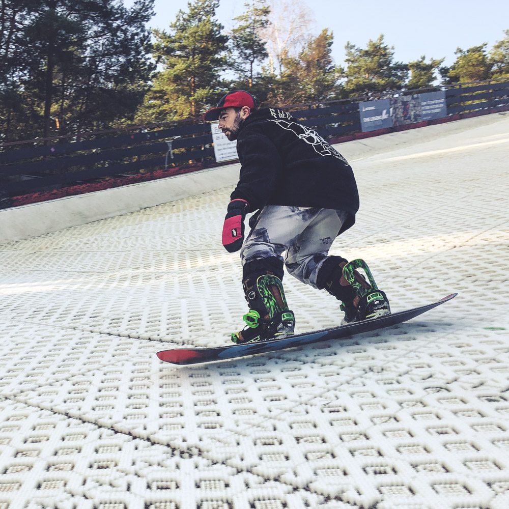 A rider dropping into a sunlit snow slope
