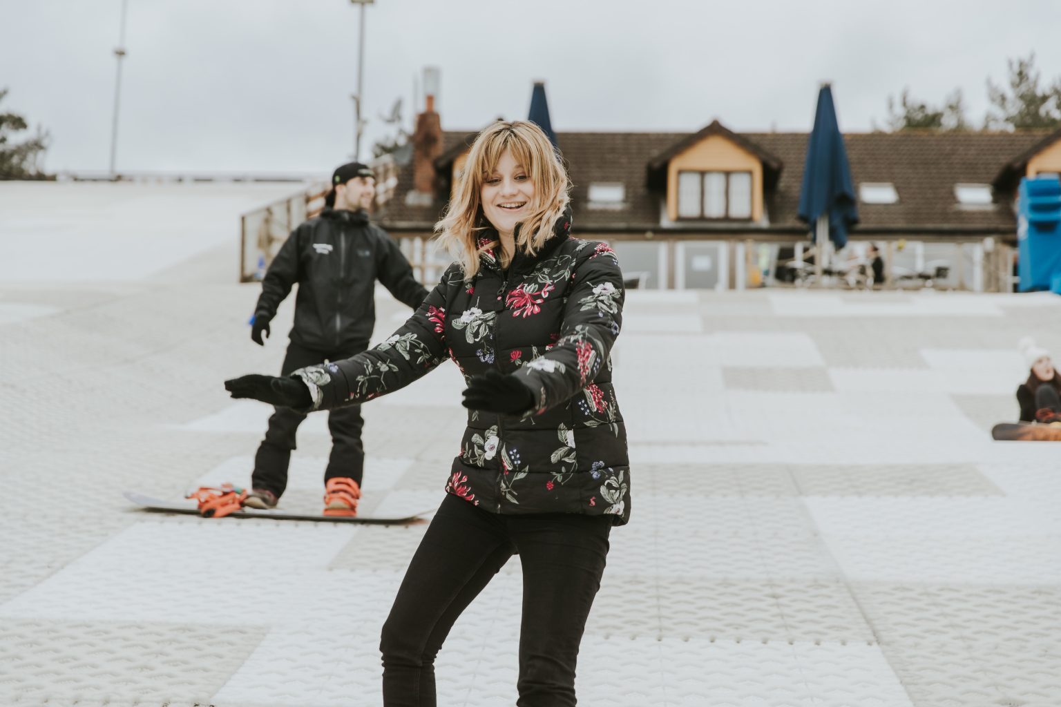 "A snowboarder mid-turn on a bright slope"